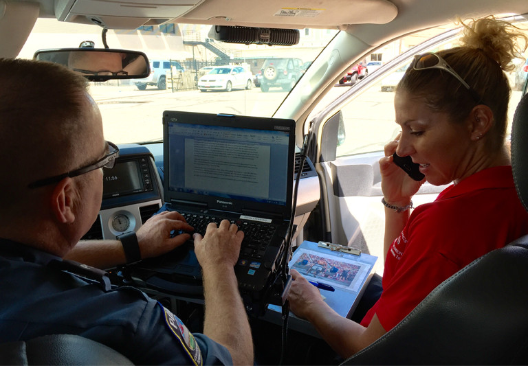 Photo of two members of Community Response Team in vehicle.